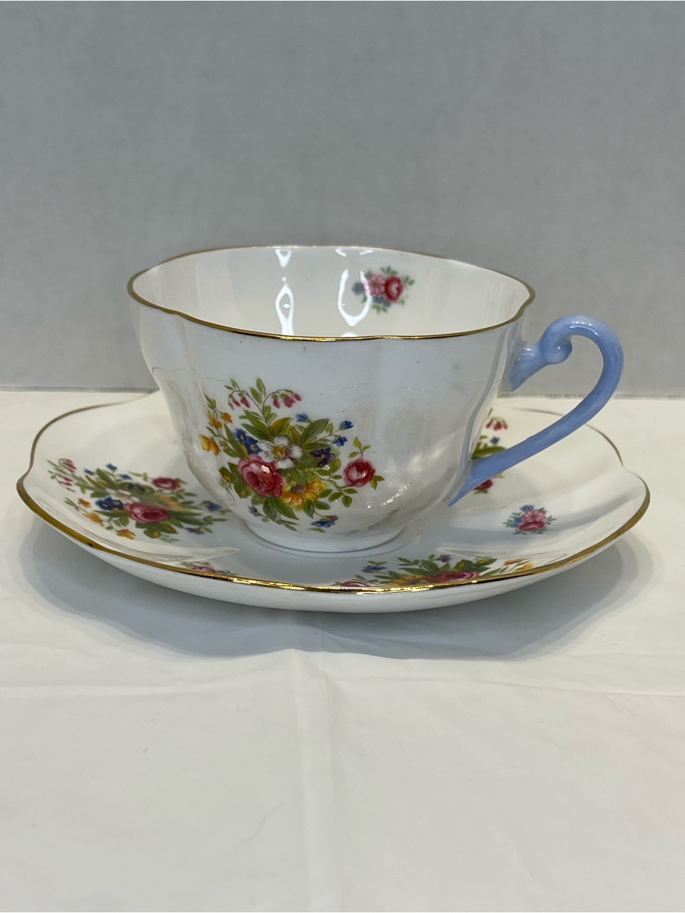 Shelley Bone China Teacup and Saucer Set with Blue Handle and Floral Design